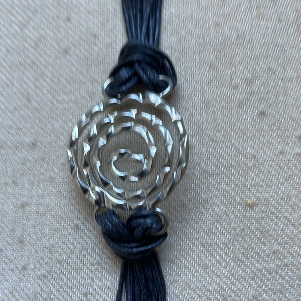 Sterling silver and black leather bracelet.